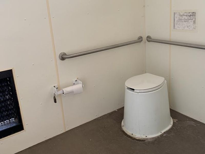 Inside the pit toilet building.