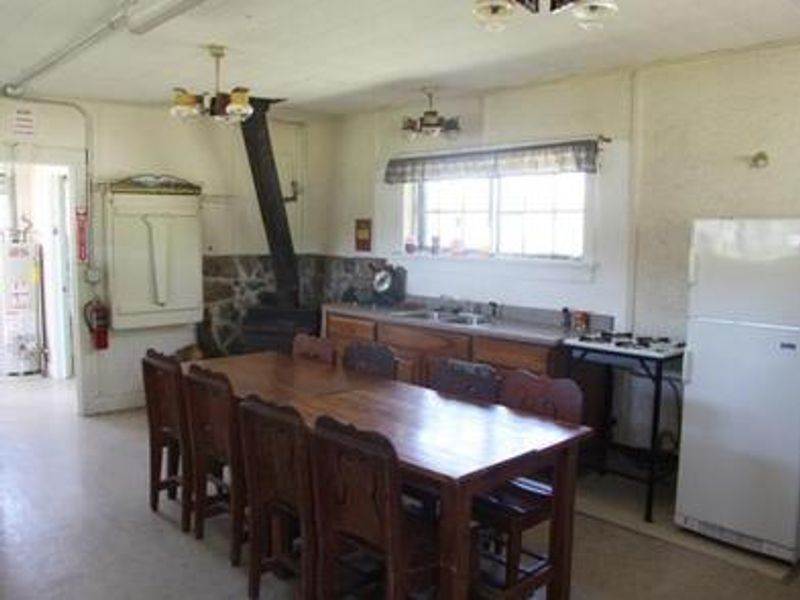 fridge, sink, woodstove, table