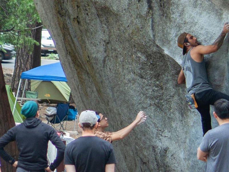 This is a photo of the Camp 4 campground with climbers bouldering in the foreground.
