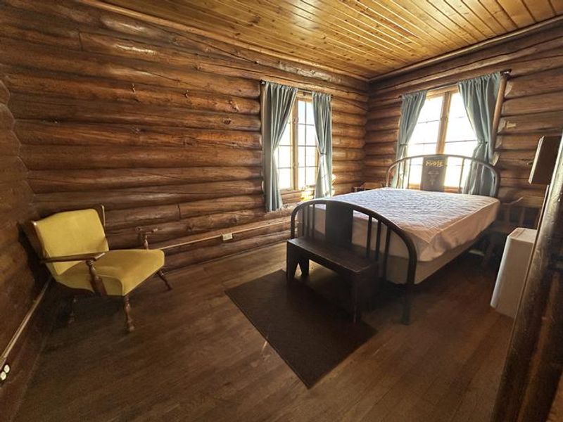 This room includes a double bed and chair.