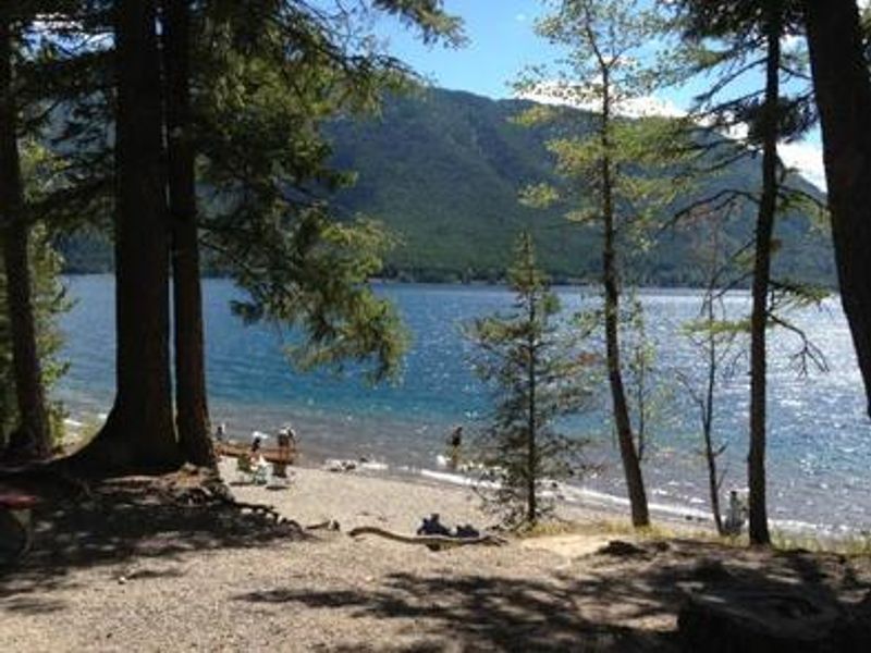 A sandy beach on Lake McDonald at Fish Creek Campground