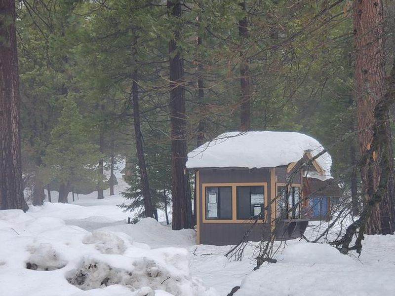 Camp 4 kiosk with piles of snow around it.