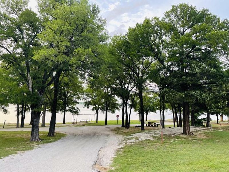 A photo of facility JUNIPER POINT with Picnic Table, Electricity Hookup, Fire Pit, Shade, Waterfront, Water Hookup