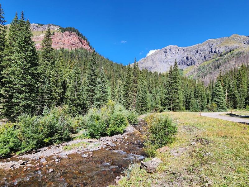 South Mineral Creek running behind campground wiht mountains in the background