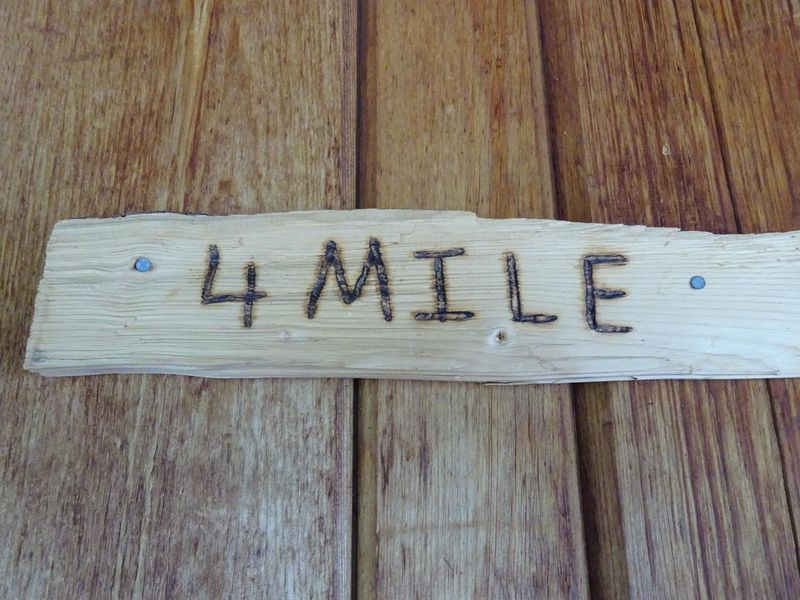 Rustic sign on Fourmile Cabin door