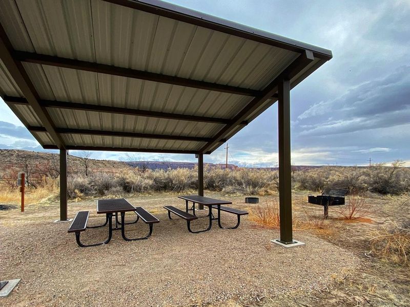 Westwater Group Site picnic tables underneath shade shelter.