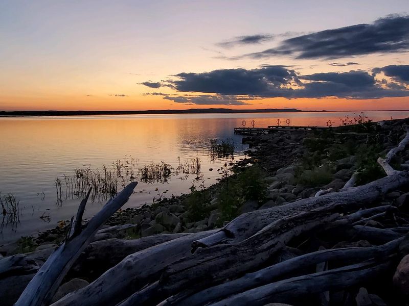 The sun sets over the calm waters of Lake Oahe at the Hazelton Boat Ramp.