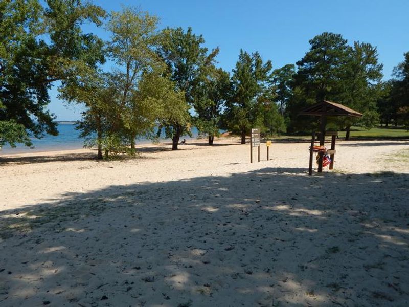 This is a photo of the designated swimming area at Palmer Point. There is a nice sandy beach area with a few trees for shade. There is also a life jacket loaner station where you can borrow and return life jackets of many different sizes. 