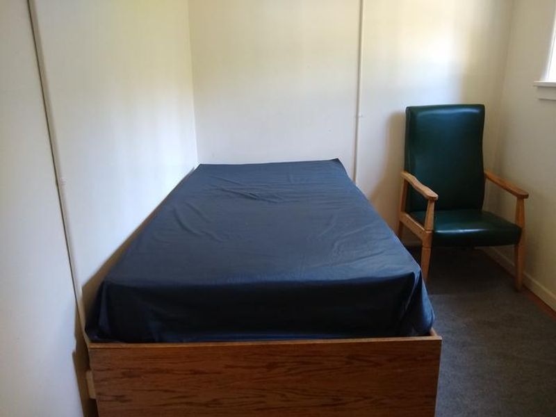 One of two bedrooms, each with a twin-sized bed.