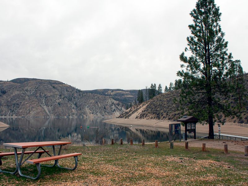 A view through a waterfront campsite to the boat launch.