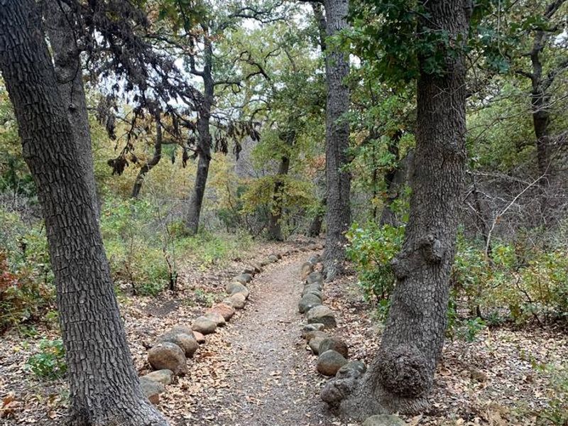 Stones line the edges of the Quanah Parker Lake Trail which leads from Doris Campground to the Environmental Education Complex and includes an accessible fishing pier.
