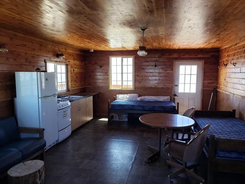 Interior View of Kitchen, Twin Beds, Table, and Chairs