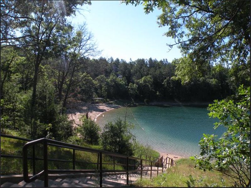 A view of Kneff Lake and the Kneff Lake Day Use area beach from a staircase. 