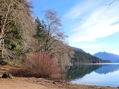 View of trees, lake, and mountains from the boat launch