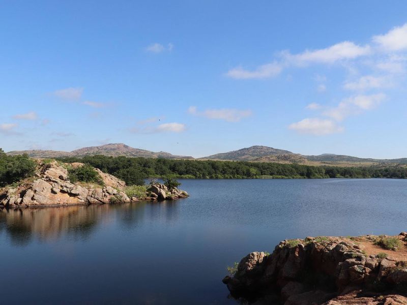The Wichita Mountains line the horizon beyond the shore of Quanah Parker Lake.