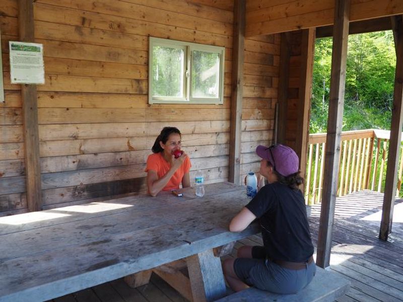 Visitors enjoying lunch outdoors at Deep Bay Cabin