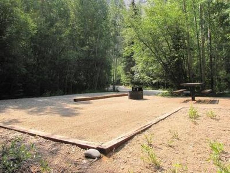 Photo of campsite with fire pit and picnic table