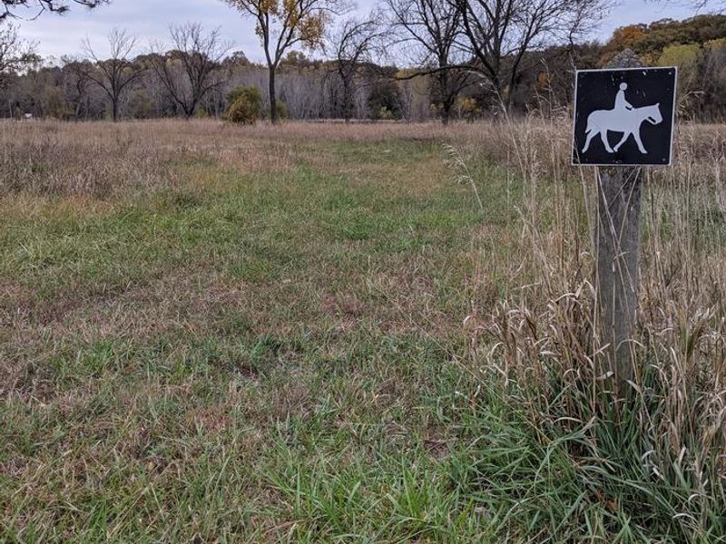 Small sign showing the horse trail route