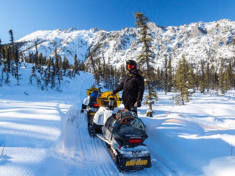 A snowmachine rider stops to enjoy the scenery along the Fossil Creek Trail in the White Mountains National Recreation Area.