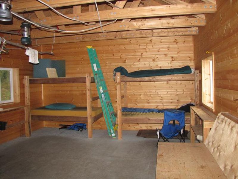 A view of bunks and bench inside Esker Stream Cabin (Wrangell-St Elias)