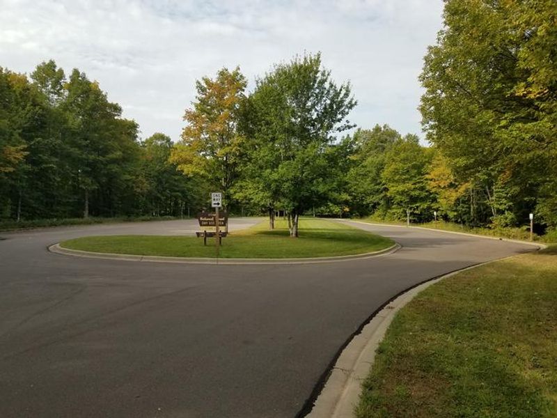 View of the parking area for the Clark Lake pavilion and day use area from the eastern end of the parking lot, as you enter the parking area.