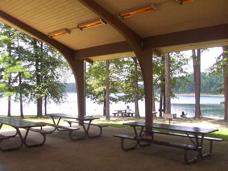 Pavilion with electricity, tables, grills, and short walking distance to swim beach.