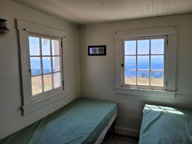 The bedroom has two single beds