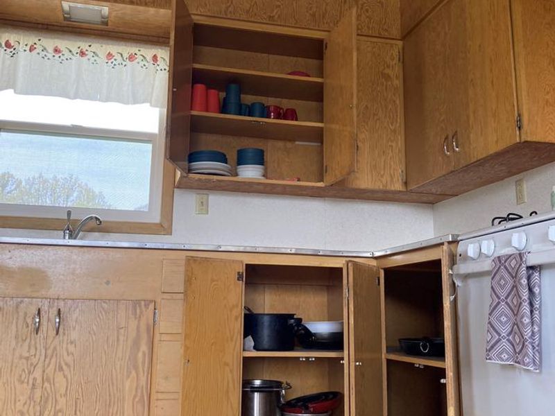 Some basic cooking pans and dining utensils are stored in the cabinets of both Orange Olsen Dwelling and Cabin.