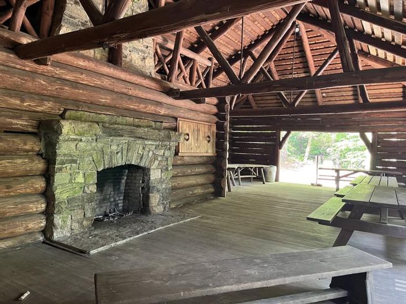 A photo of facility CAVE MOUNTAIN LAKE GROUP PICNIC SHELTER with Picnic Table, Fire Pit, Shade