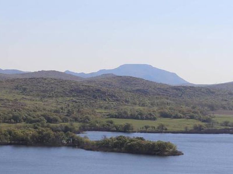 The Wichita Mountains line the horizon beyond the shore of Quanah Parker Lake.