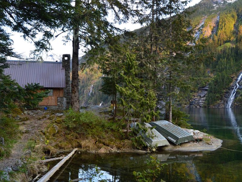 View of cabin and lake