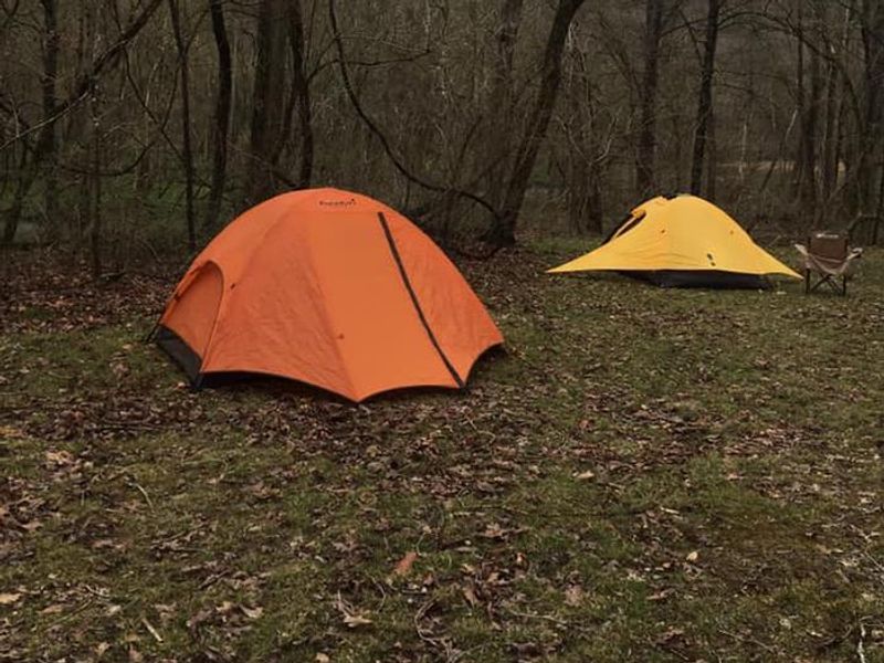 An orange and a yellow tent  pitched at Round Spring