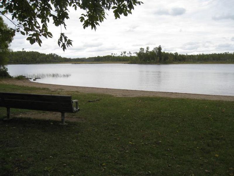 Fall Lake Beach Area.  Area contains benches and sand beach.  Located near play area and picnic sites.