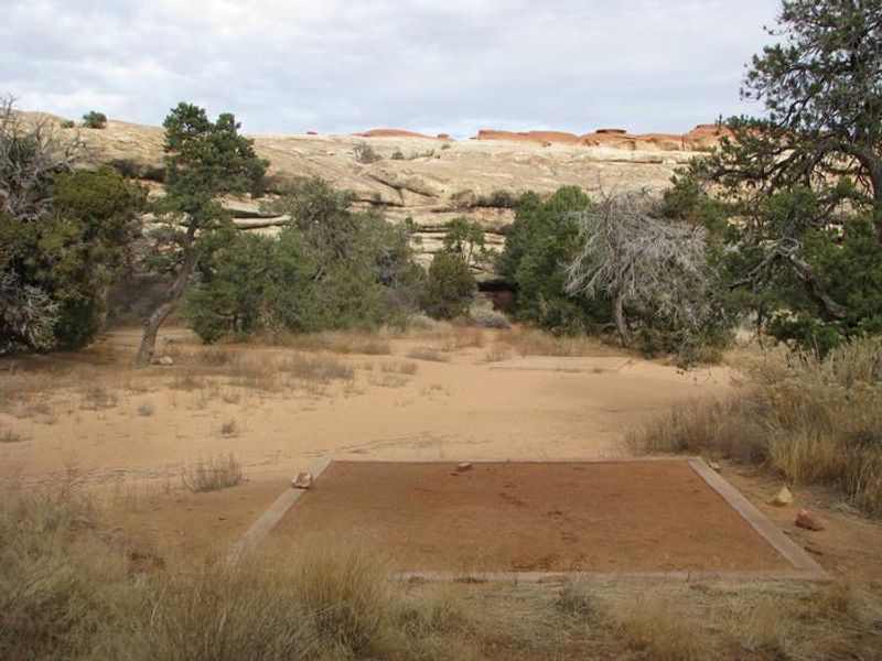Tent pad and surrounding sand and slickrock.
