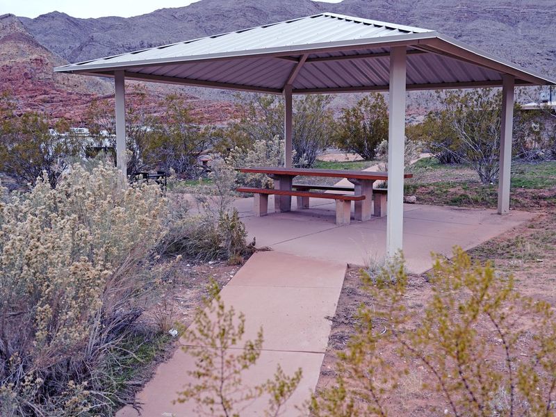 Site with ADA walkways, picnic table, and fire pit