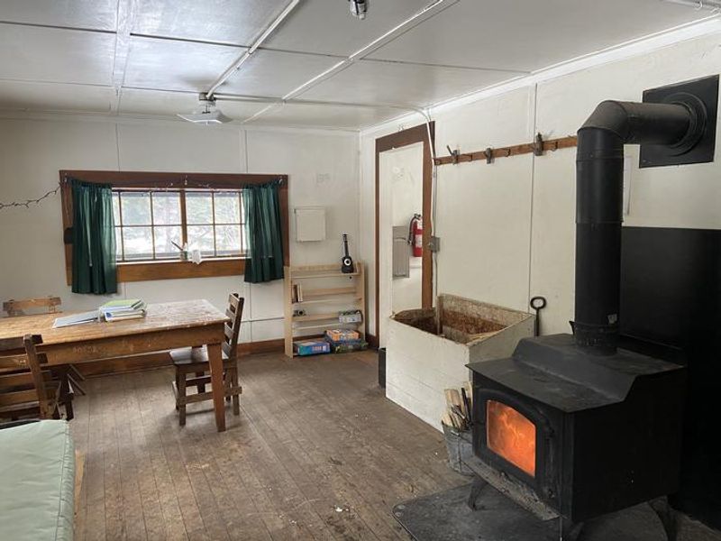 Warm stove glowing on a bright winter day at West Boulder Cabin
