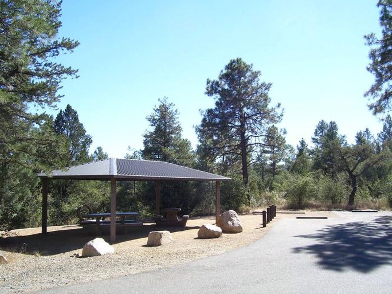 Camp site with covered picnic benches.