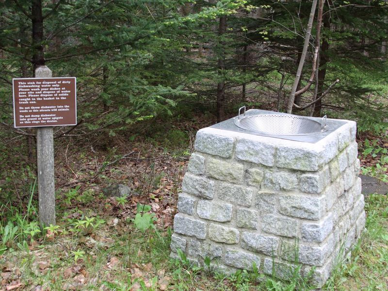 Sink where campers pour dirty water from a container after washing dishes at campsite. (This is NOT a dishwashing station).