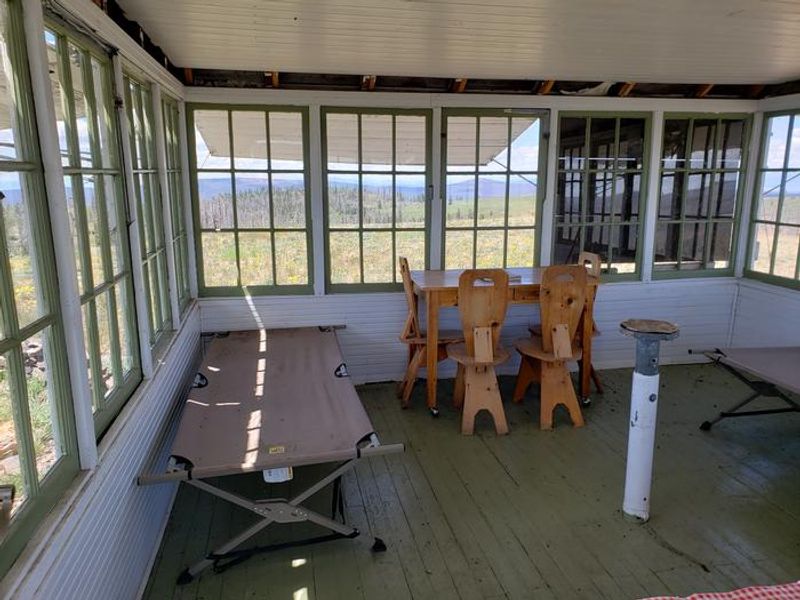 Interior of Lookout Showing Cots, Table, and Seating