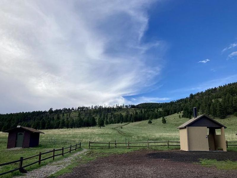 Bath house (left side of photo) has shower and flush toilet. Open mid- May through mid - October.
Vault toilet on right is open from mid - April through mid-November